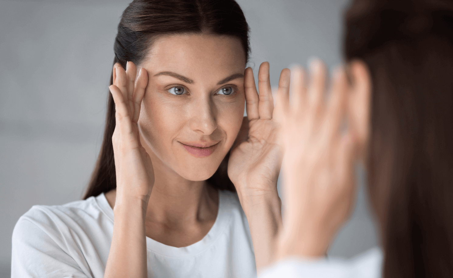 Woman in the Mirror after dermal fillers