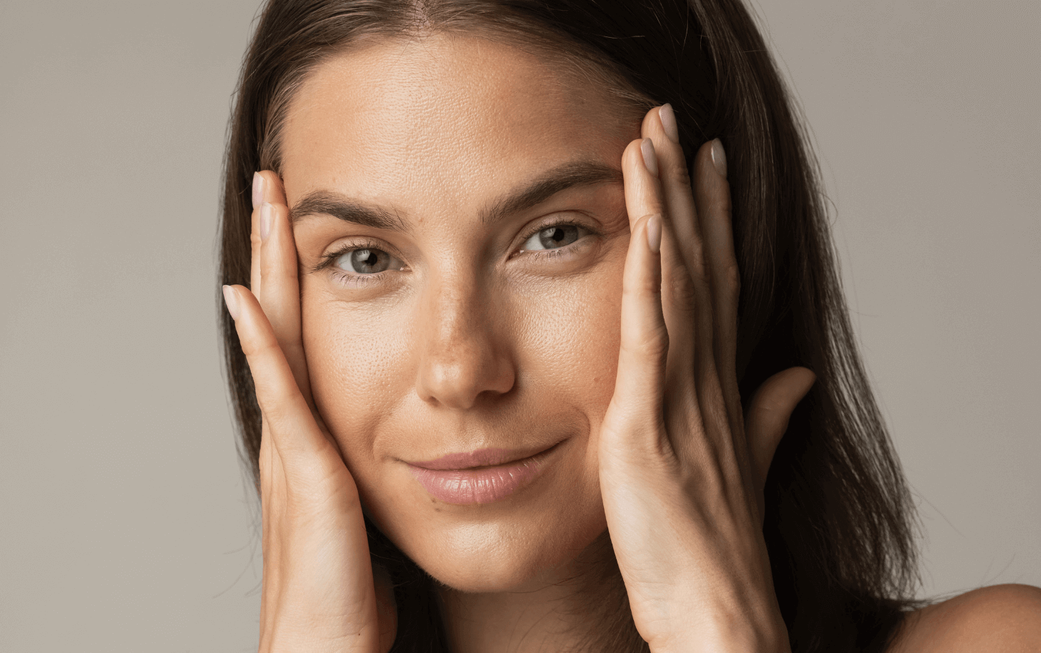 woman with an envy facial in Newmarket holding face